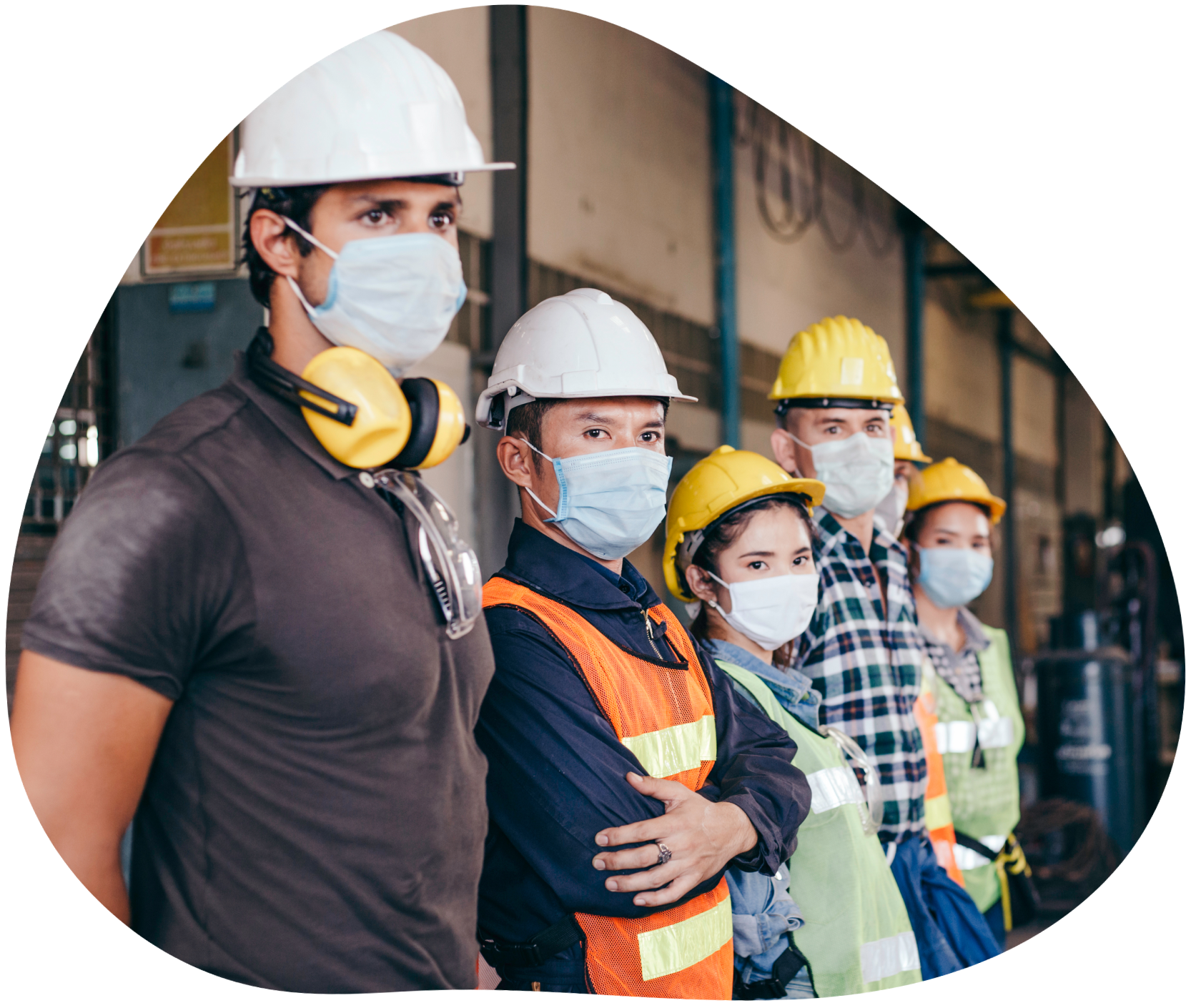 Lineup of construction workers wearing masks and hard hats