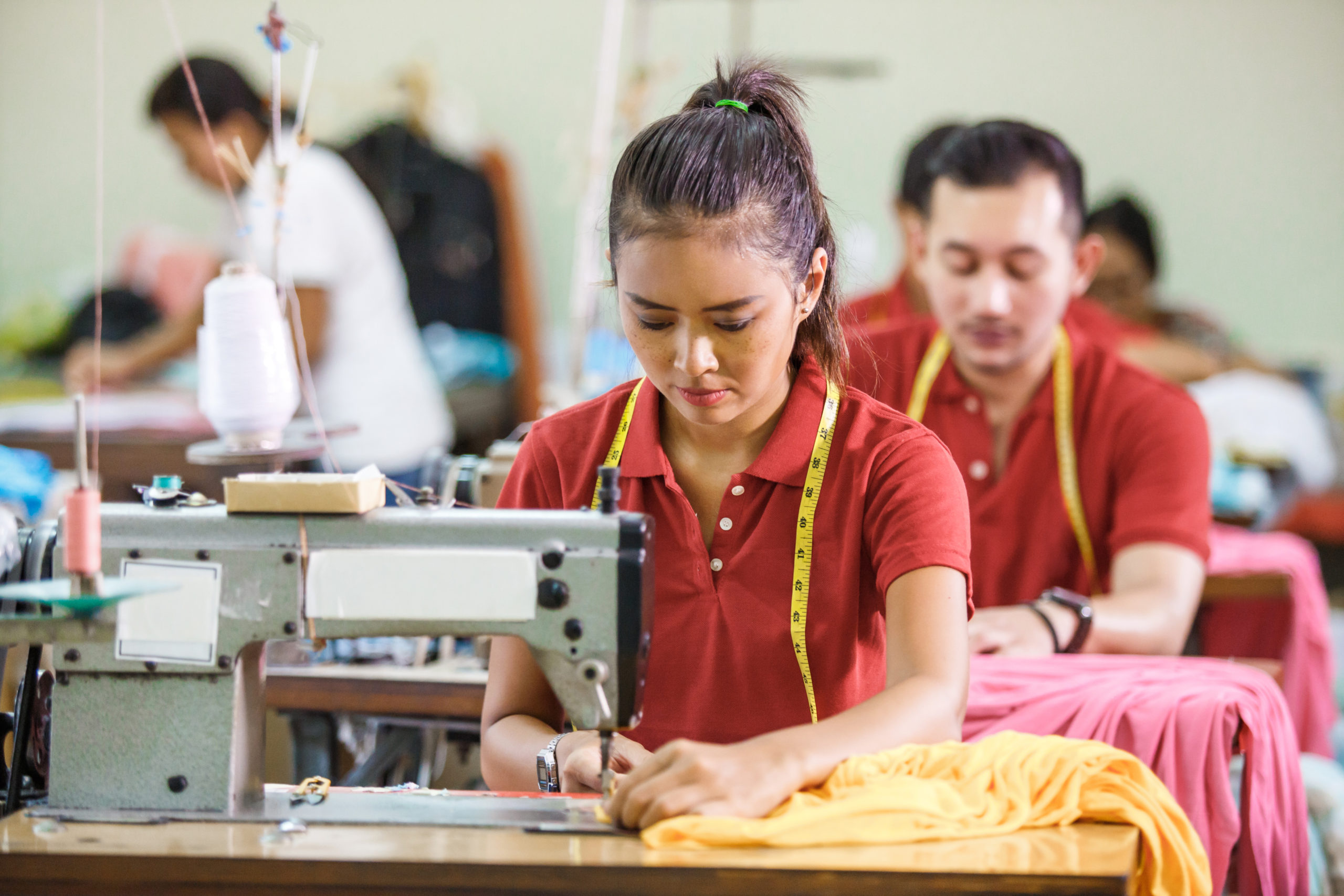 Garment workers operating sewing machine